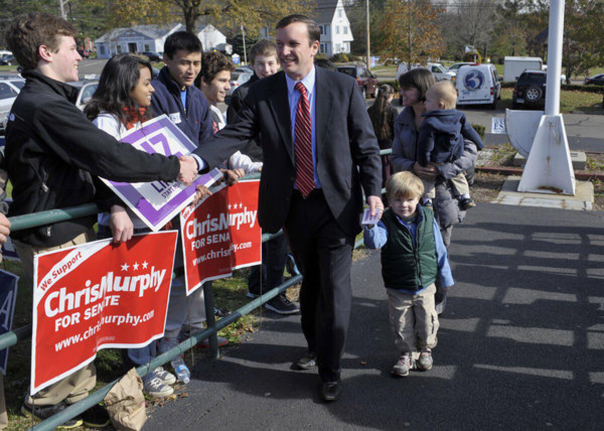 Democratic U.S. Senate candidate Chris Murphy arrives with his family to vote in Cheshire, Conn.