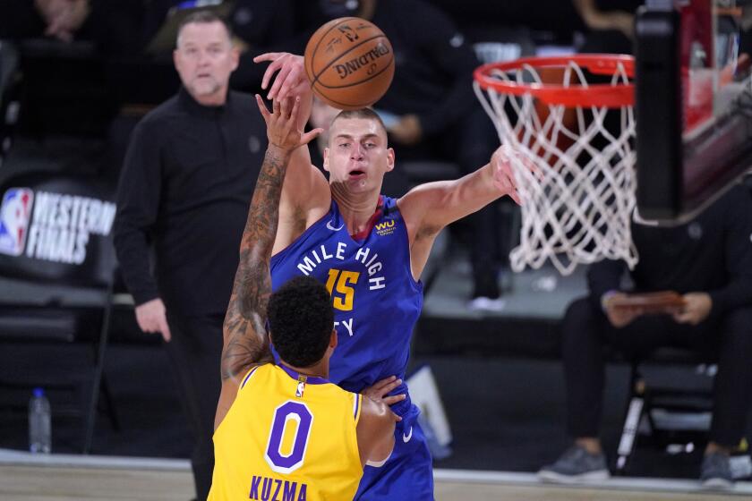 Los Angeles Lakers forward Kyle Kuzma (0) and Denver Nuggets center Nikola Jokic (15) compete for control of a rebound during the first half an NBA conference final playoff basketball game Friday, Sept. 18, 2020, in Lake Buena Vista, Fla. (AP Photo/Mark J. Terrill)
