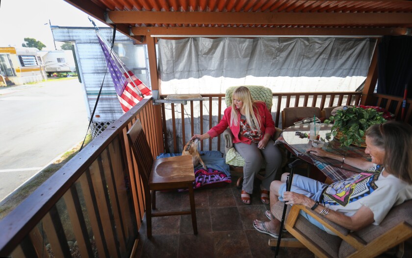 Neighbors Maria Hirneisen, left, and Tricia Harrelson, right, each have lived at Siesta RV Park on Palm Avenue in Imperial Beach for more than 20 years. Now they, along with the rest of the residents, face an uncertain future because the trailer park could be sold to a developer.