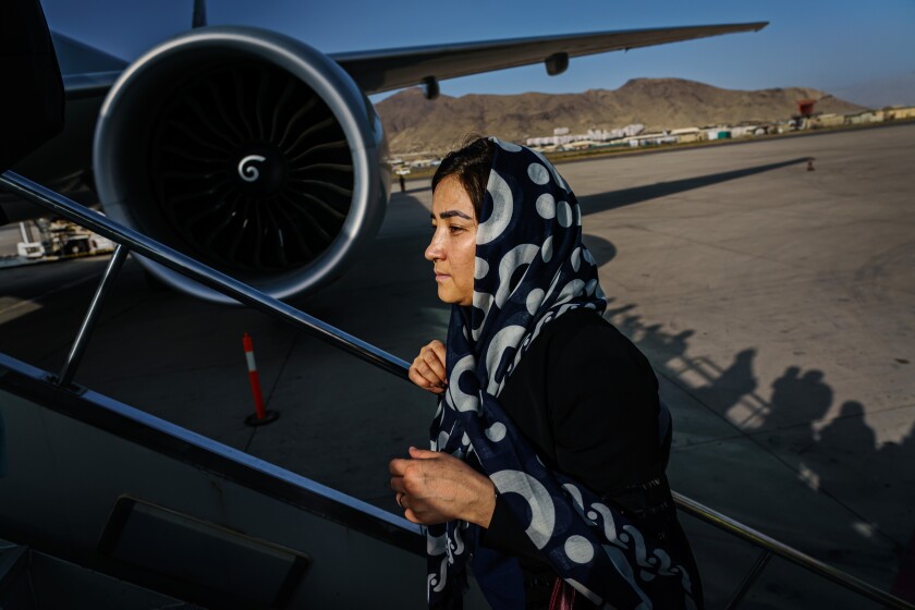 Humaira Rasa boards an evacuation flight out of the country with other Afghan nationals,