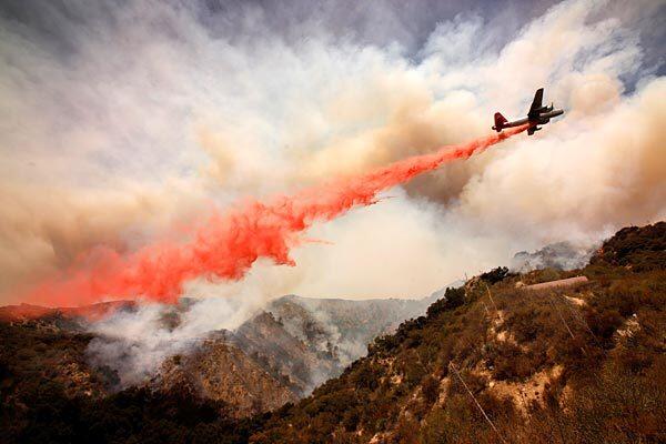 More fire retardant is dropped as the fire moved down a canyon in the hills above La Cañada Flintridge.