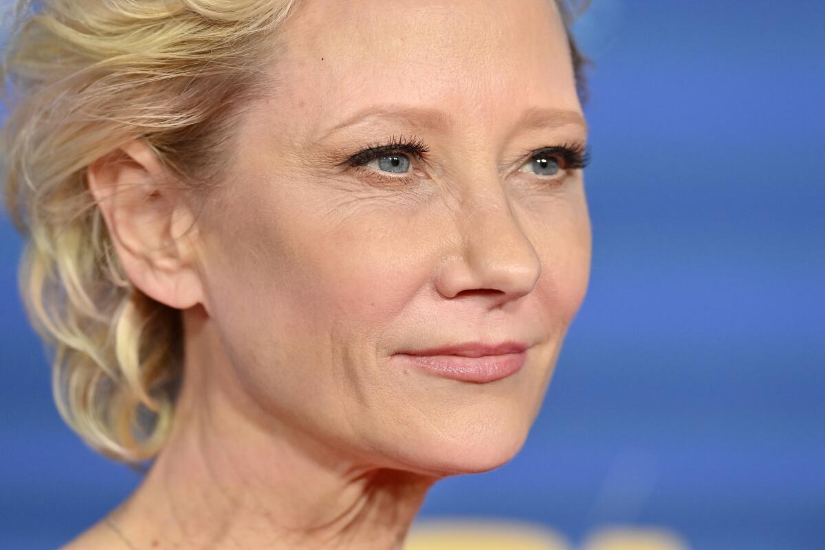 Actress Anne Heche poses at an awards show red carpet