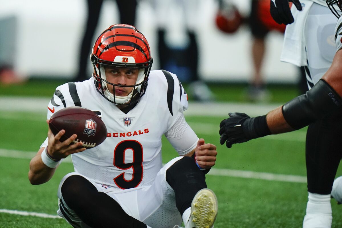 Cincinnati Bengals quarterback Joe Burrow reacts as he sits on the ground during the second half of an NFL football game against the New York Jets, Sunday, Oct. 31, 2021, in East Rutherford, N.J. (AP Photo/Frank Franklin II)