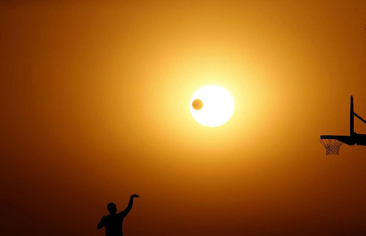 The sun sets on the Autumnal Equinox, the first day of fall, at Angels Gate Park in San Pedro on Sept. 22. Weather forecasts call for soaring temperatures through Monday afternoon.