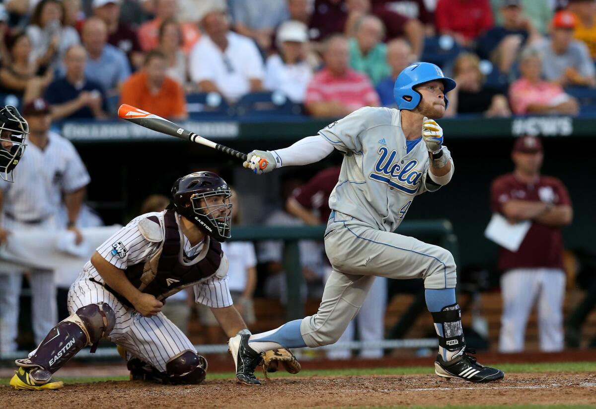 UCLA's Eric Filia hits a two-run single against Mississippi State during the College World Series on June 24, 2013.