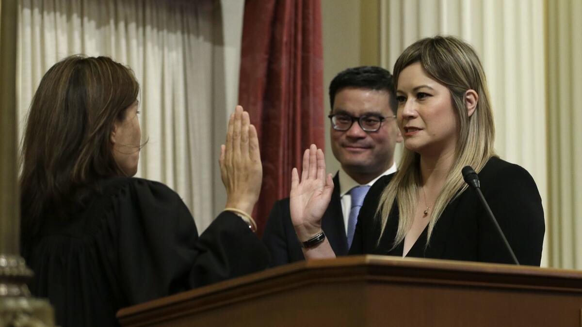 State Sen. Ling Ling Chang (R-Diamond Bar), right, shown being sworn in on June 25, wants Caltrans to remove road signs that identify gas tax revenue as the funding source for certain projects.