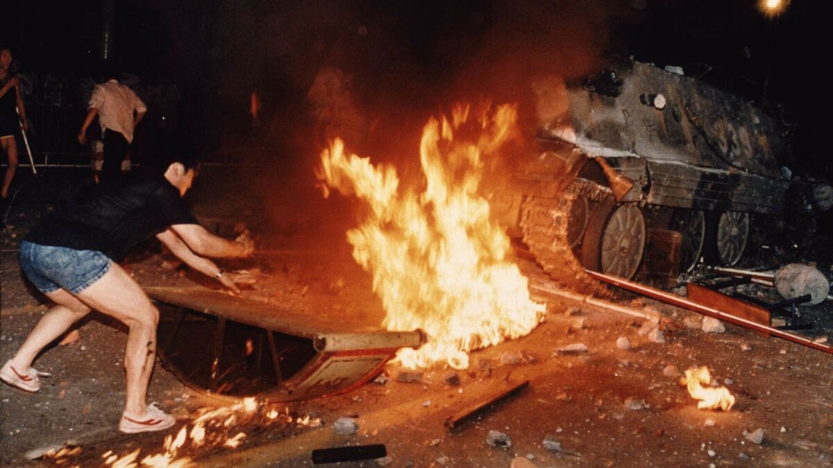 On June 4, 1989, a Chinese protester tried to block an already burning armored personnel carrier that rammed through protest lines during an army attack on anti-government demonstrators. A soldier who escaped the armored vehicle was killed by demonstrators.