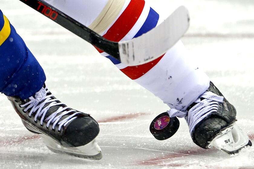 Sweden and the Czech Republic face off in the third period of a men's ice hockey game Wednesday at the 2014 Winter Olympics. Hockey requires a smooth surface to keep the puck from skipping.