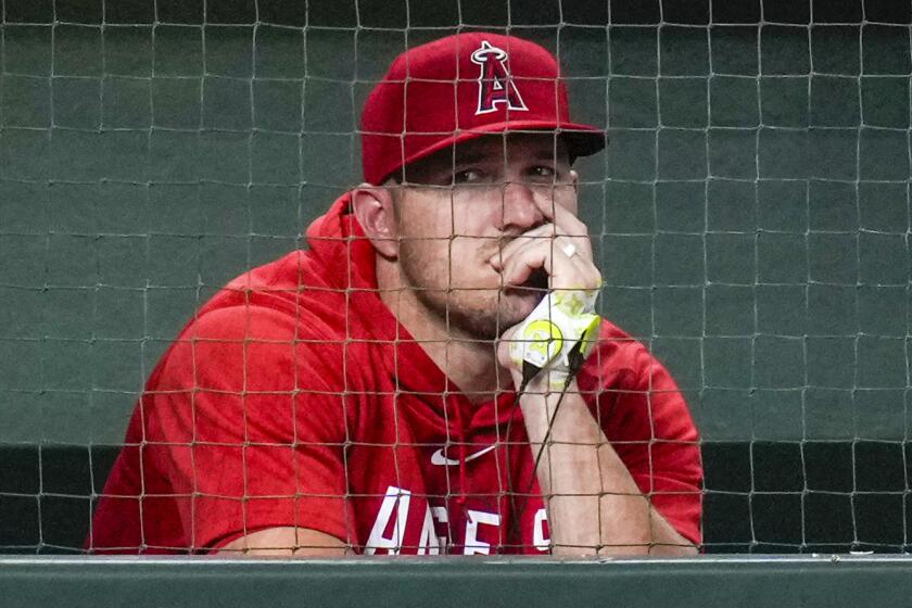 Los Angeles Angels' Mike Trout watches from the dugout during the ninth inning on Aug. 11, 2023, in Houston.