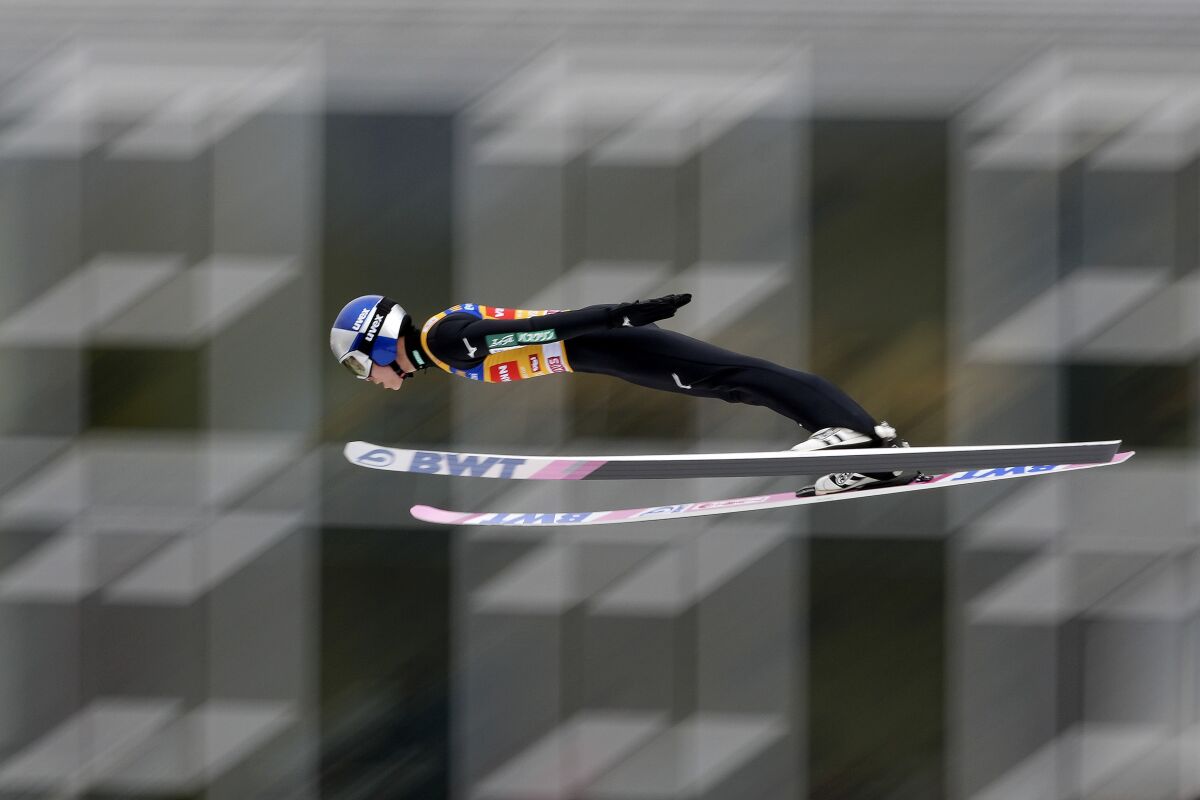 FILE -Ryoyu Kobayashi of Japan soars through the air during his second trial jump at the third stage of the 70th Four Hills ski jumping tournament in Innsbruck, Austria, Monday, Jan. 3, 2022. Even World-class athletes who compete in ski jumping and a former Olympian paid to analyze the sport have no idea who will win gold in Beijing. Defending Olympic champion Kamil Stoch has an injured left leg that is knocking him out of World Cup competition this week in his native Poland and puts his status for the 2022 Winter Olympics up in the air. Japan's Ryoyu Kobayashi is the world's top-ranked ski jumper. (AP Photo/Matthias Schrader, File)