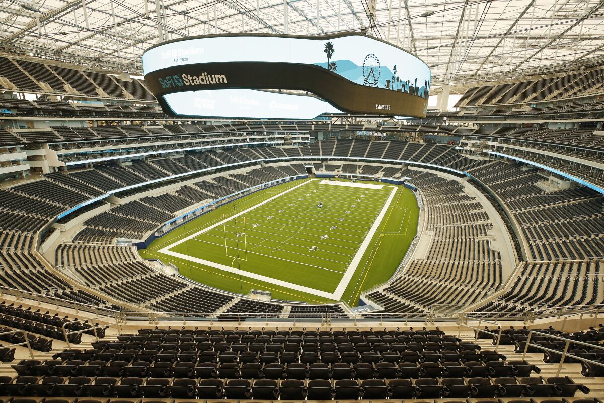 SoFi Stadium interior photo showing the huge video board over the field.