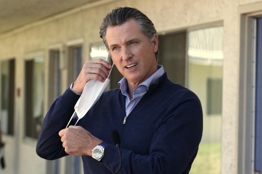 FILE - In this June 30, 2020, file photo, Gov. Gavin Newsom removes his face mask before giving an update during a visit to Pittsburg, Calif. Newsom said in a statement Friday, Nov. 13, that he should not have attended a birthday dinner with a dozen people at the posh French Laundry restaurant last week, saying that he should have set a better example for a virus-fatigued state that is seeing steep increases in coronavirus cases. Newsom’s decision to attend was made as he’s been telling others to not mingle with others outside their households. (AP Photo/Rich Pedroncelli, Pool, File)