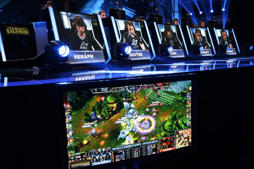 FILE - Competitors play in a "League of Legends" championship series video game competition at the Penny Arcade Expo, a fan-centric celebration of gaming, in Seattle on Aug. 29, 2014. On Tuesday, Dec. 28, 2021, Riot Games, the publisher behind the esports game, agreed to pay $100 million to settle a class-action lawsuit alleging pay disparity, gender discrimination and sexual harassment. (AP Photo/Ted S. Warren, File)