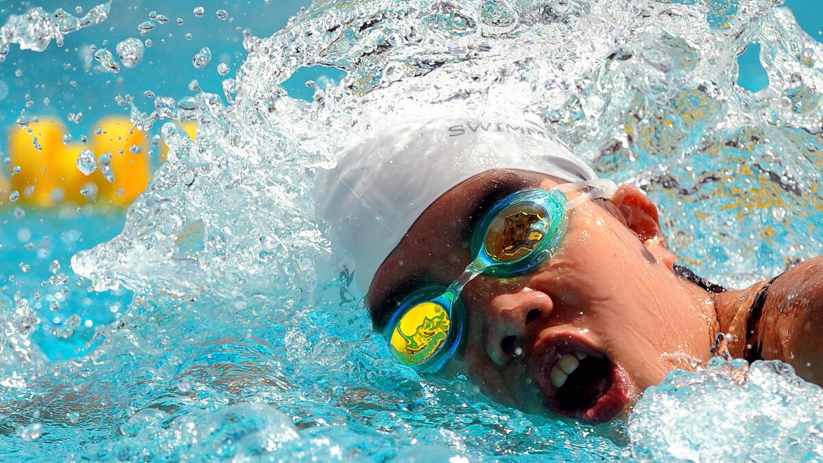 A swimmer competes in the 100m freestyle in the Special Olympics at USC Monday.
