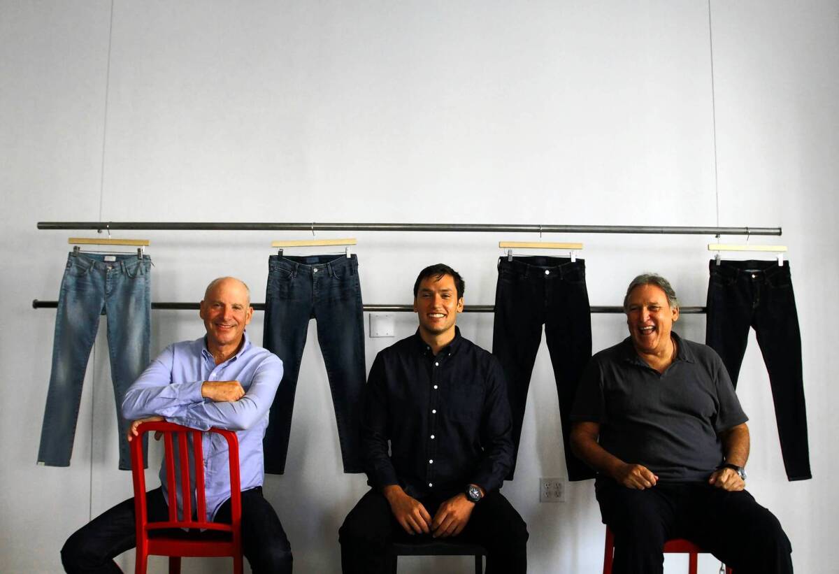 The new line of jeans from Koral Los Angeles features a range of washes and colors. Rick Crane, left, David Koral and Peter Koral (David’s father) run the firm.