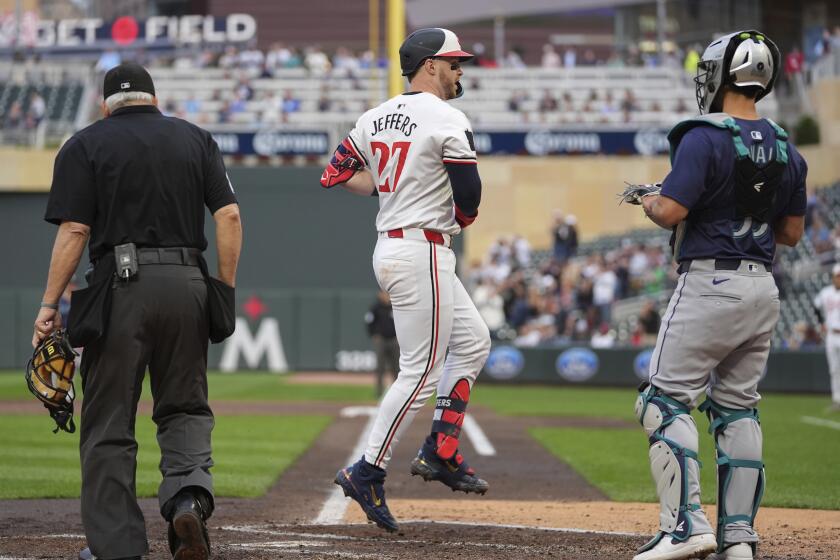 Minnesota Twins' Ryan Jeffers (27) crosses home plate after hitting a 3-run home run during the third inning of a baseball game against the Seattle Mariners, Tuesday, May 7, 2024, in Minneapolis. (AP Photo/Abbie Parr)
