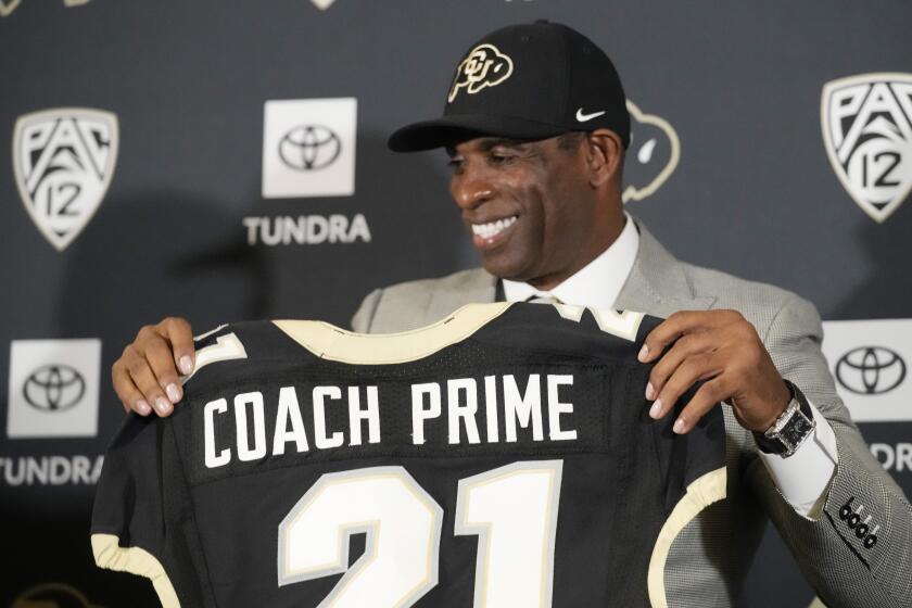 Deion Sanders speaks after being introduced as the new head football coach at the University of Colorado 