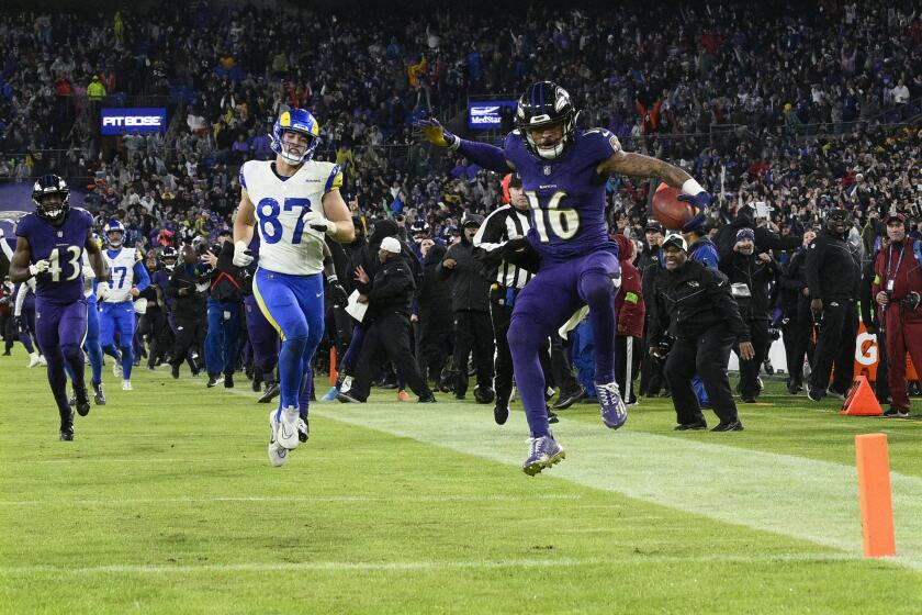 The Ravens' Tylan Wallace (16) completes his 76-yard punt return in overtime to beat the Rams.