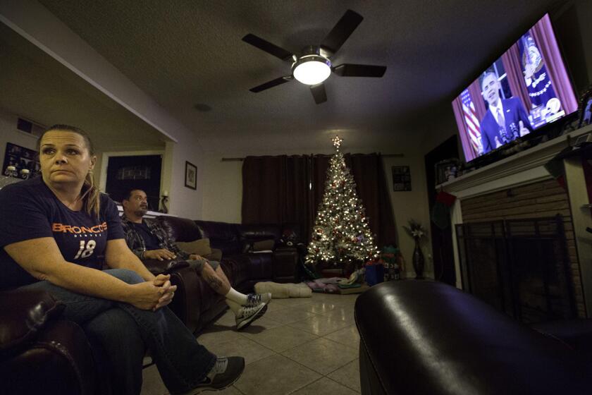 Trish Hughes, left, a Democrat, and husband Robert Garcia, right, a Republican, watched President Obama's speech together at their home in San Bernardino.