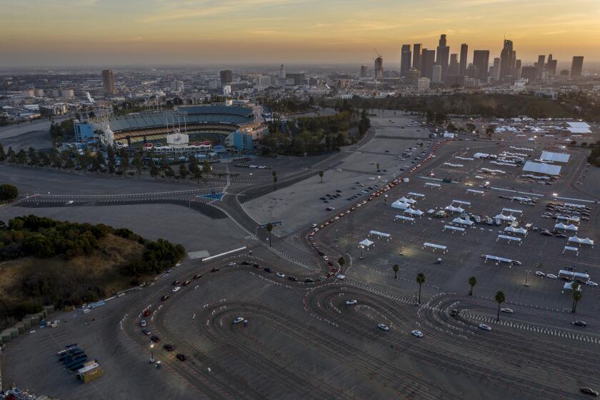 Los Angeles, CA, Monday, February 8, 2021 - Hundreds line up to get Covid-19 vaccine shots at Dodger Stadium. (Robert Gauthier/Los Angeles Times)
