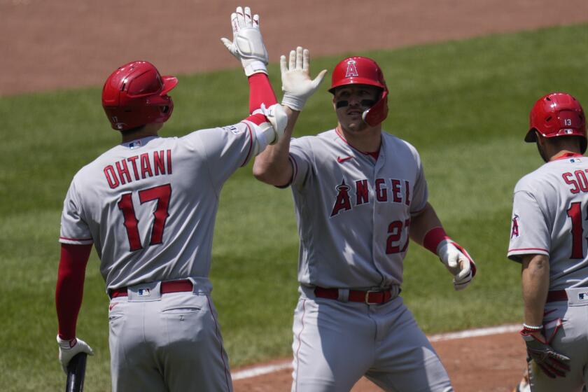 Los Angeles Angels designated hitter Shohei Ohtani (17) celebrates with Mike Trout (27) after Trout hit a home run.