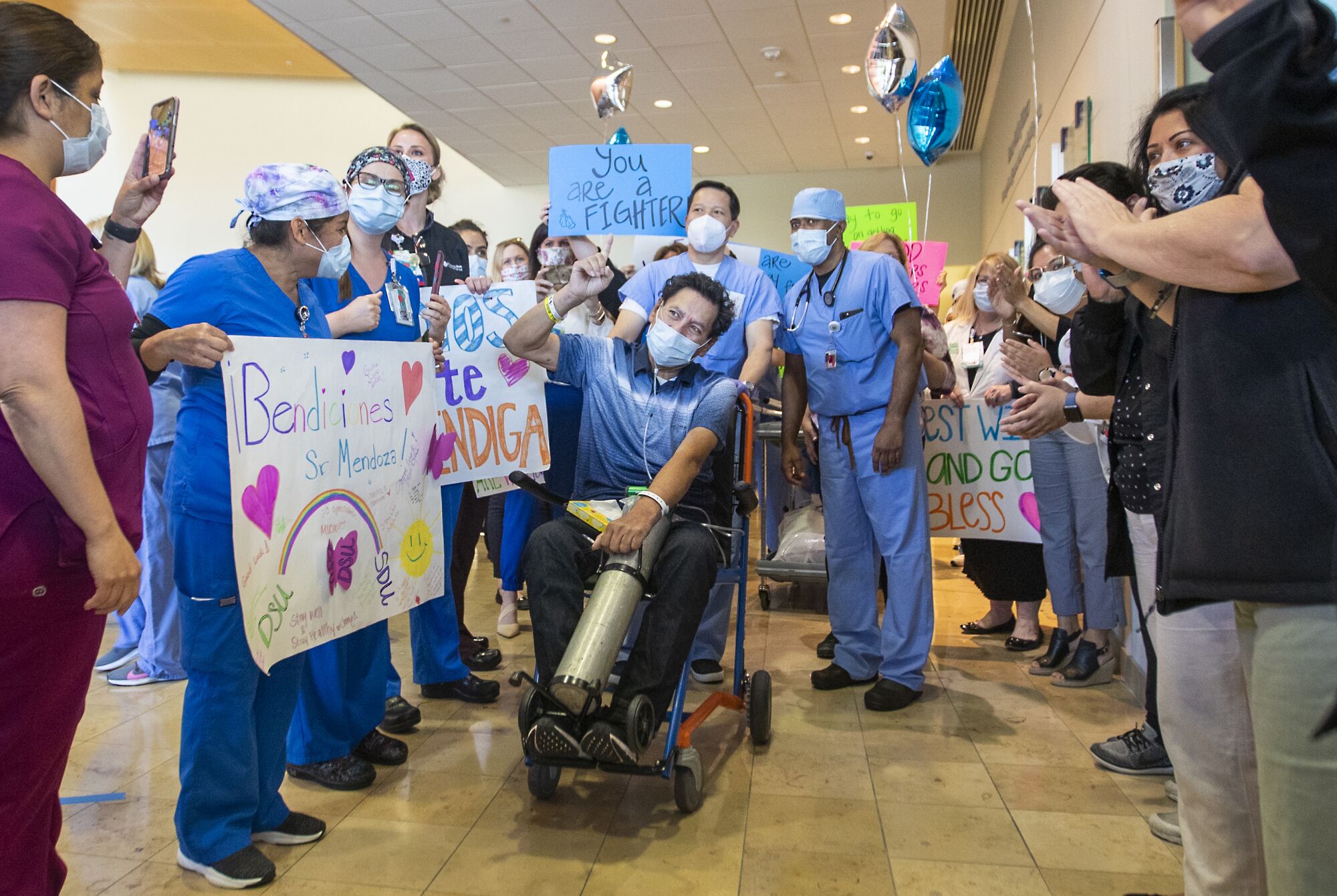 Armando Mendoza, 53, of Anaheim, celebrates with all his health-care professionals and his family after spending 45 days at St. Joseph Hospital in Orange. Mendoza was the hospital's second-ever COVID-19 patient.
