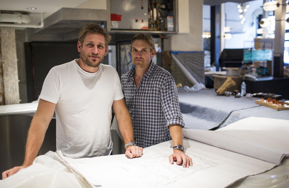 Australian Chef Curtis Stone, left, and his brother Luke Stone are seen at Gwen during construction.