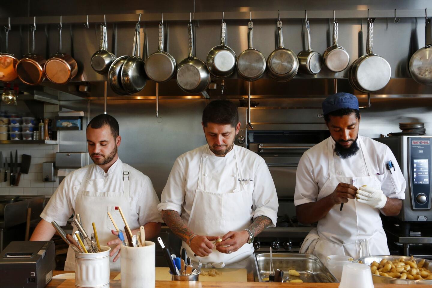In the kitchen at Trois Mec are, from left, chef de cuisine Douglas Rankin, chef Ludo Lefebvre, and line cook Brandon Gray.