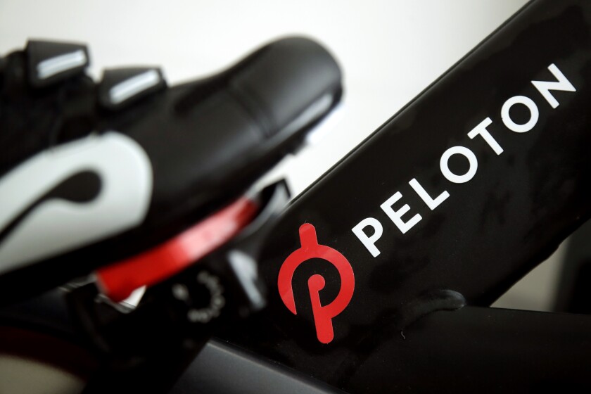 FILE - This Nov. 19, 2019 file photo shows the logo on a Peloton bike in San Francisco. Peloton's shares tumbled on Thursday, Jan. 20, 2022, after a media report said the exercise and treadmill company was temporarily halting production of its connected fitness products amid waning consumer demand. (AP Photo/Jeff Chiu, File)