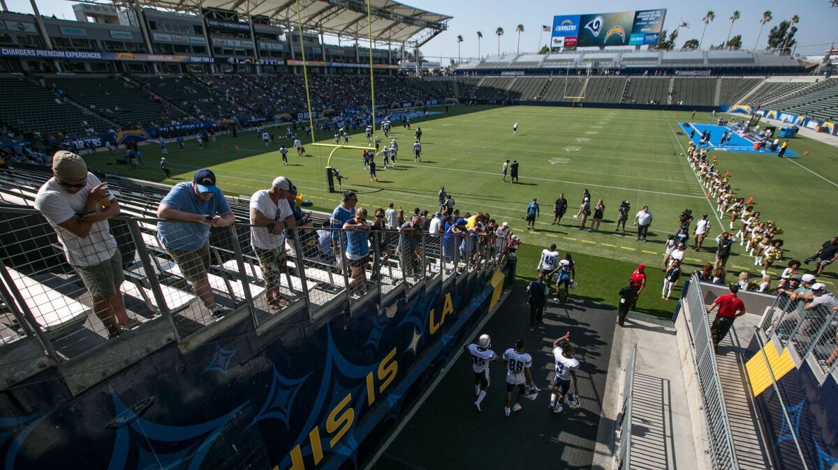 Chargers players enter the field to participate in a joint practice with the Rams at StubHub Center.