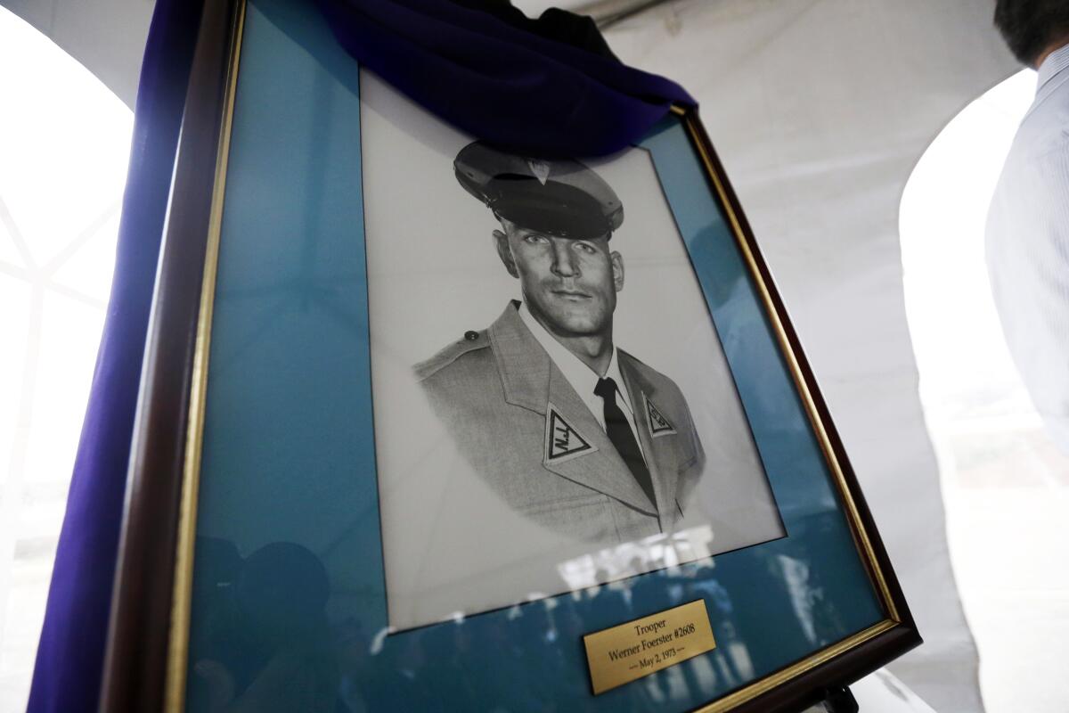 FILE — A portrait of New Jersey State Police trooper Werner Foerster is displayed during an event unveiling a monument in his honor, Nov. 18, 2015, in East Brunswick, N.J. A split New Jersey Supreme Court granted parole Tuesday, May 10. 2022, to Sundiata Acoli, a former militant convicted in the 1973 death of Foerster, in a case that has resonated for decades and been a thorny issue in U.S.-Cuba relations. (AP Photo/Julio Cortez, File)