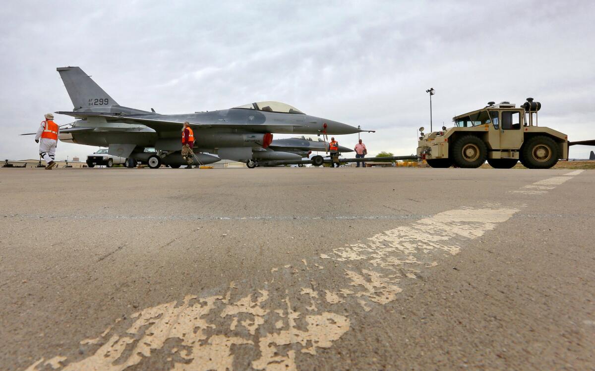 A crew tows an F-16 Fighting Falcon at Davis-Monthan Air Force Base in Tucson last month. An Iraqi pilot was flying a Fighting Falcon when he crashed Wednesday.