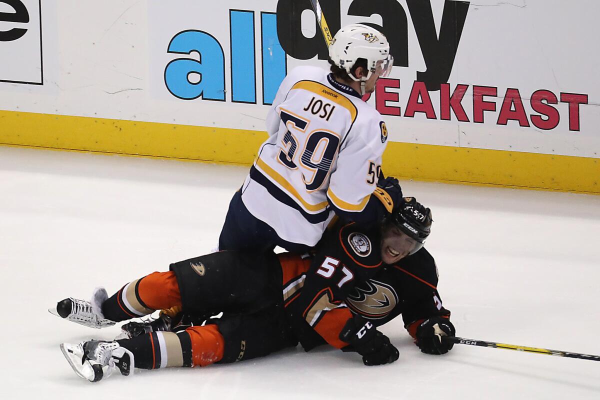 Ducks forward David Perron is knocked to the ice by Predators defenseman Roman Josi during second period action in Game 7.