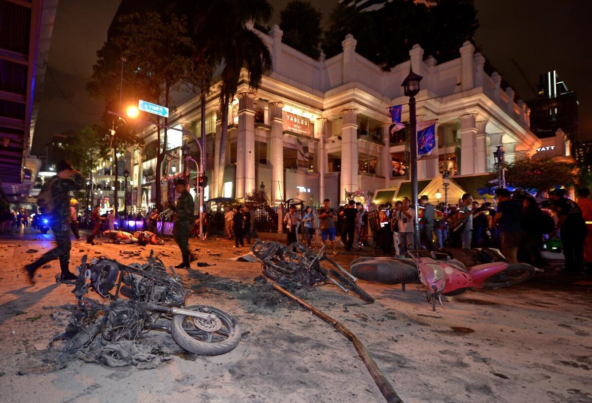 Thai soldiers inspect the scene after a bomb exploded outside a religious shrine in central Bangkok late Monday.