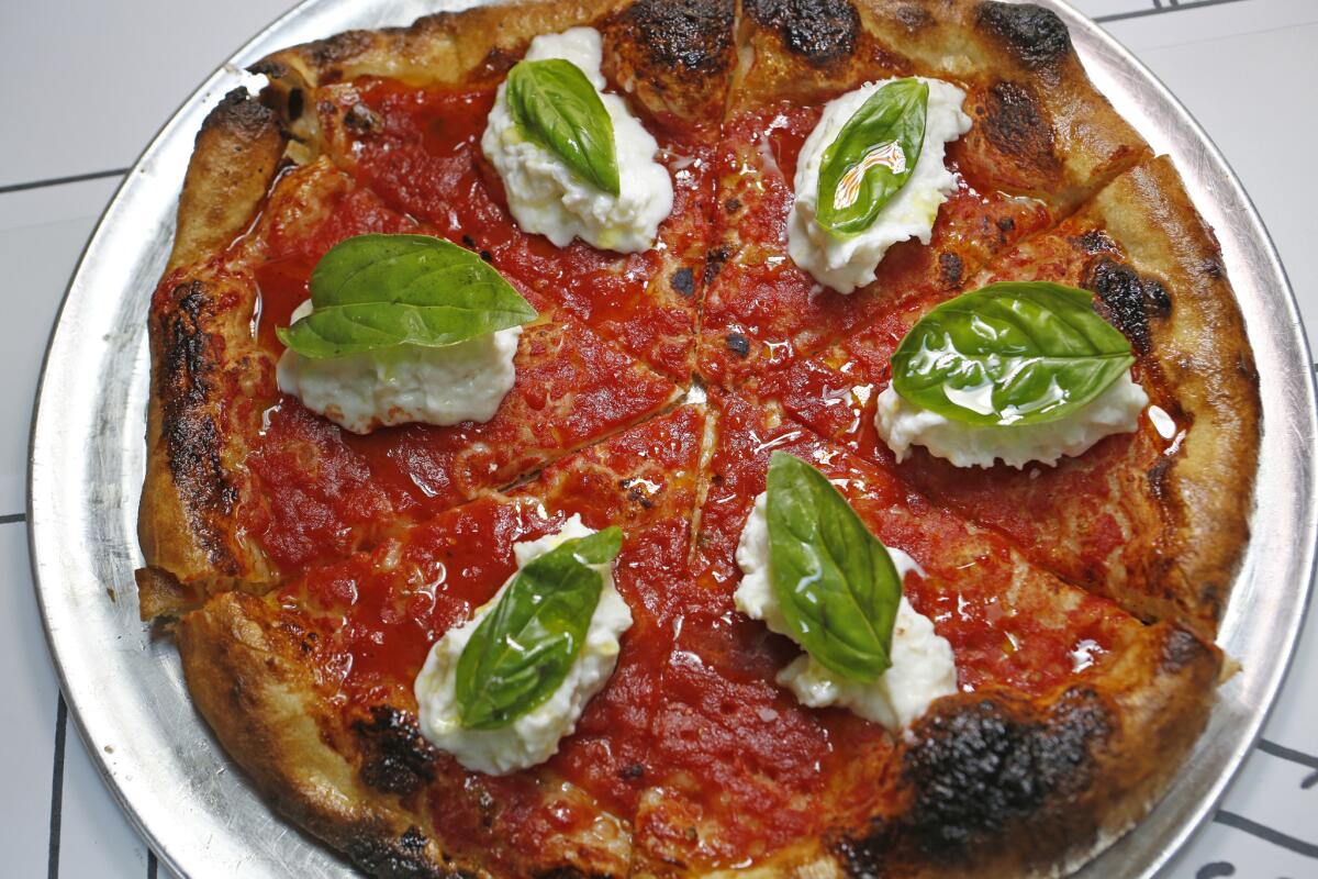 Jon & Vinny's "L.A. Woman" pizza: local burrata, tomato, basil, olive oil and sea salt.