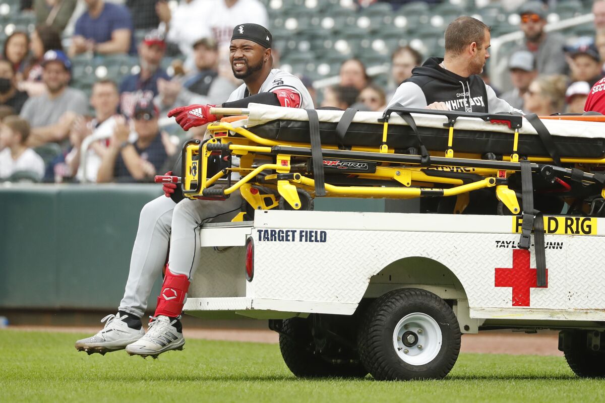 Chicago White Sox's Eloy Jimenez leaves the field on a cart after falling to the turf on a groundout to the Minnesota Twins in the second inning of a baseball game Saturday, April 23, 2022, in Minneapolis. (AP Photo/Bruce Kluckhohn)