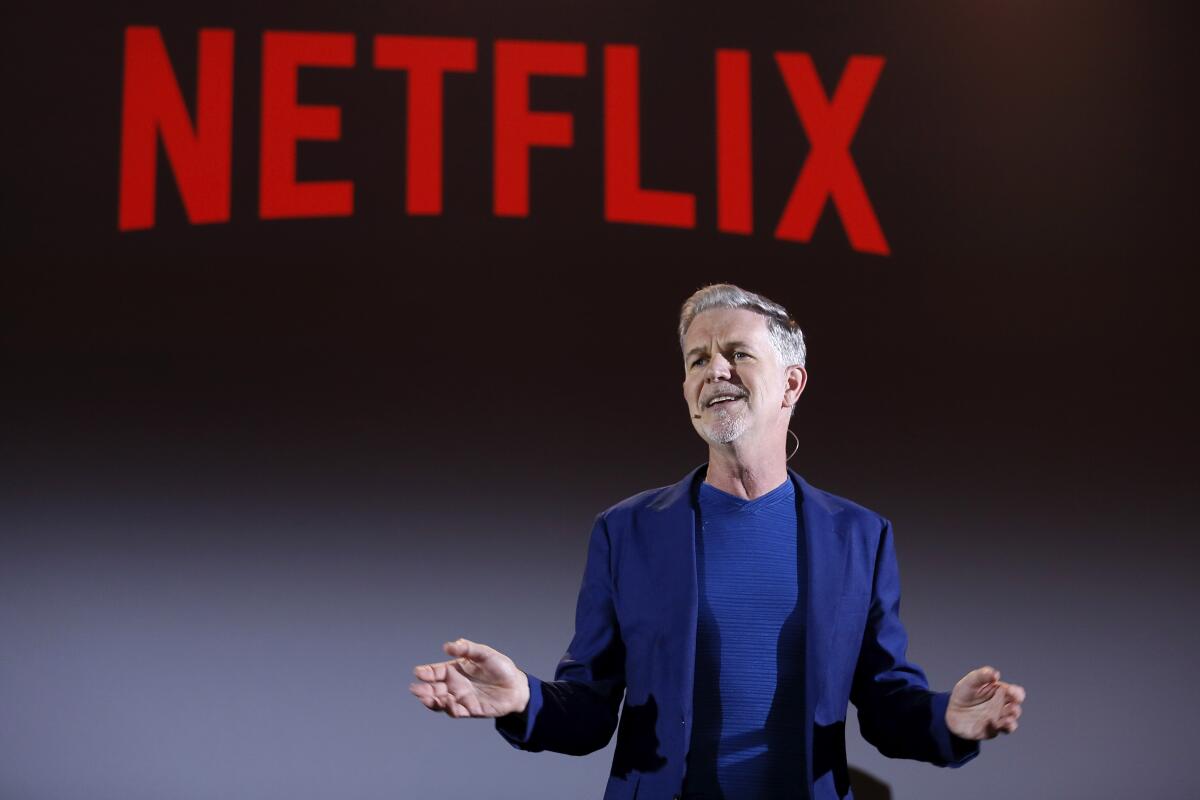 Reed Hastings with Netflix logo in the background