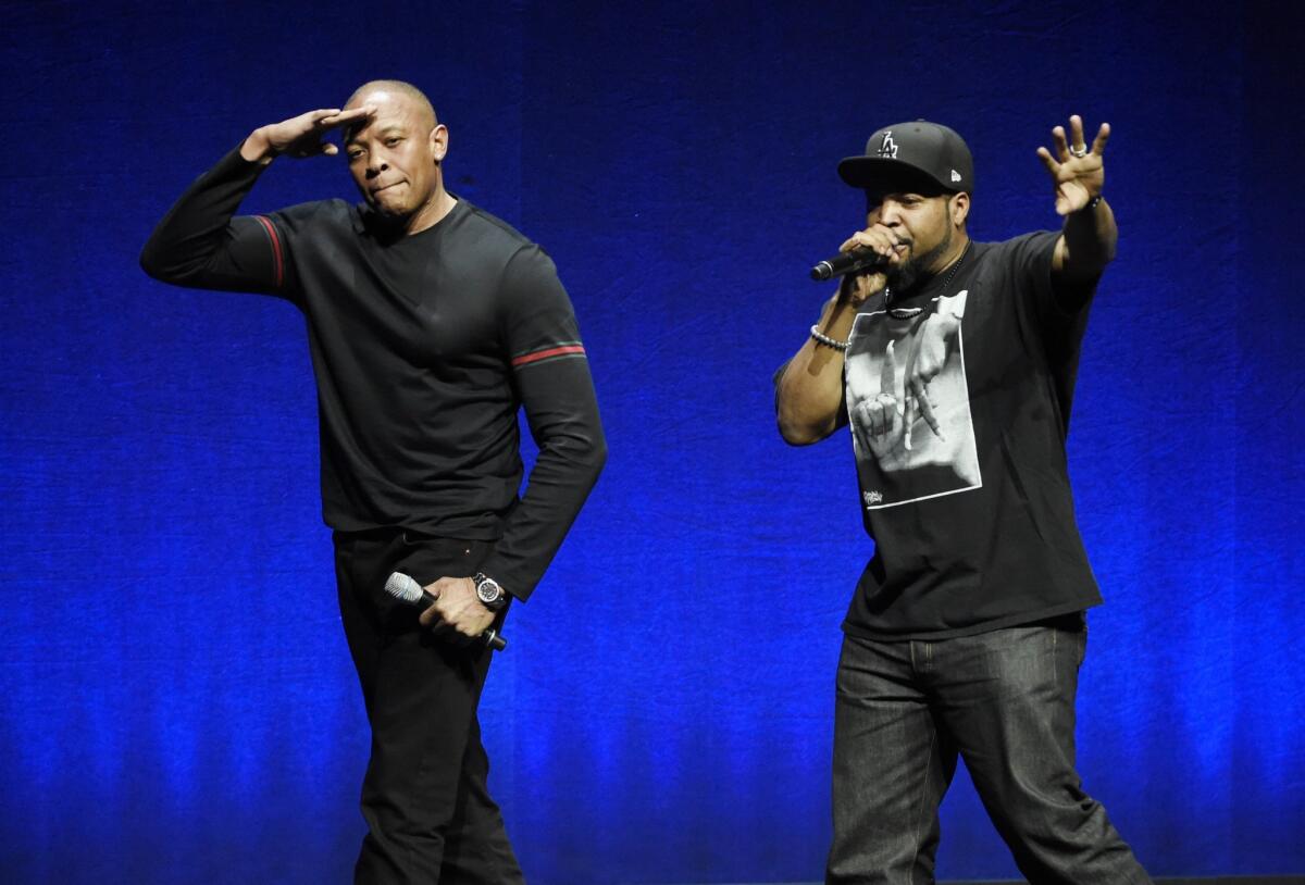 N.W.A. members Dr. Dre, left, and Ice Cube, two of the subjects of the upcoming biographical drama "Straight Outta Compton," salute the crowd after speaking at the Universal Pictures presentation during CinemaCon in Las Vegas on April 23.