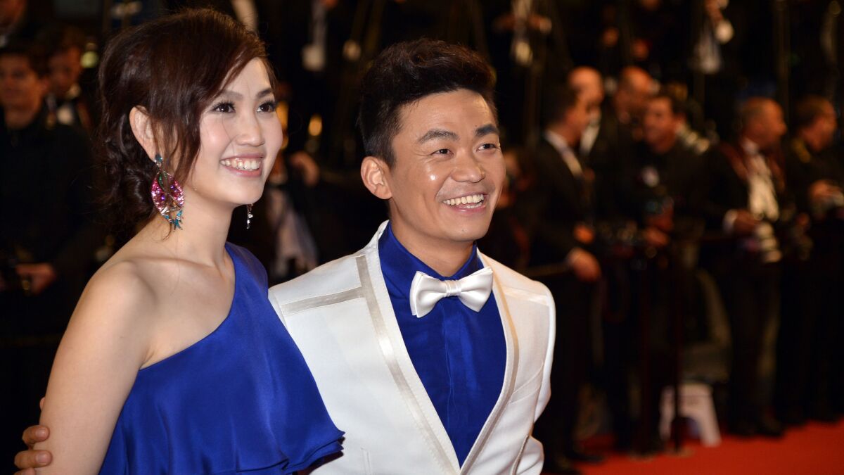 Chinese actor Wang Baoqiang, right, arrives May 17, 2013, with his wife Ma Rong for a screening of the film "Tian Zhu Ding" (A Touch of Sin) at the Cannes Film Festival in Cannes, France.