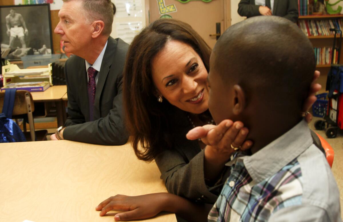 State Atty. Gen. Kamala D. Harris talks to a fifth-grade student Tuesday while she and L.A. Unified Supt. John Deasy tour classes on the first day of instruction at Baldwin Hills Elementary School in Los Angeles.