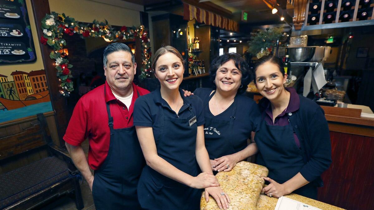 Owner Teresa Corea-Golka, second from right, poses with, from left, employee Jose Canseco, her daughter and manager Anna Golka-Yepez, and manager Marian Rodriguez at Roma D'Italia in Tustin on May 24.
