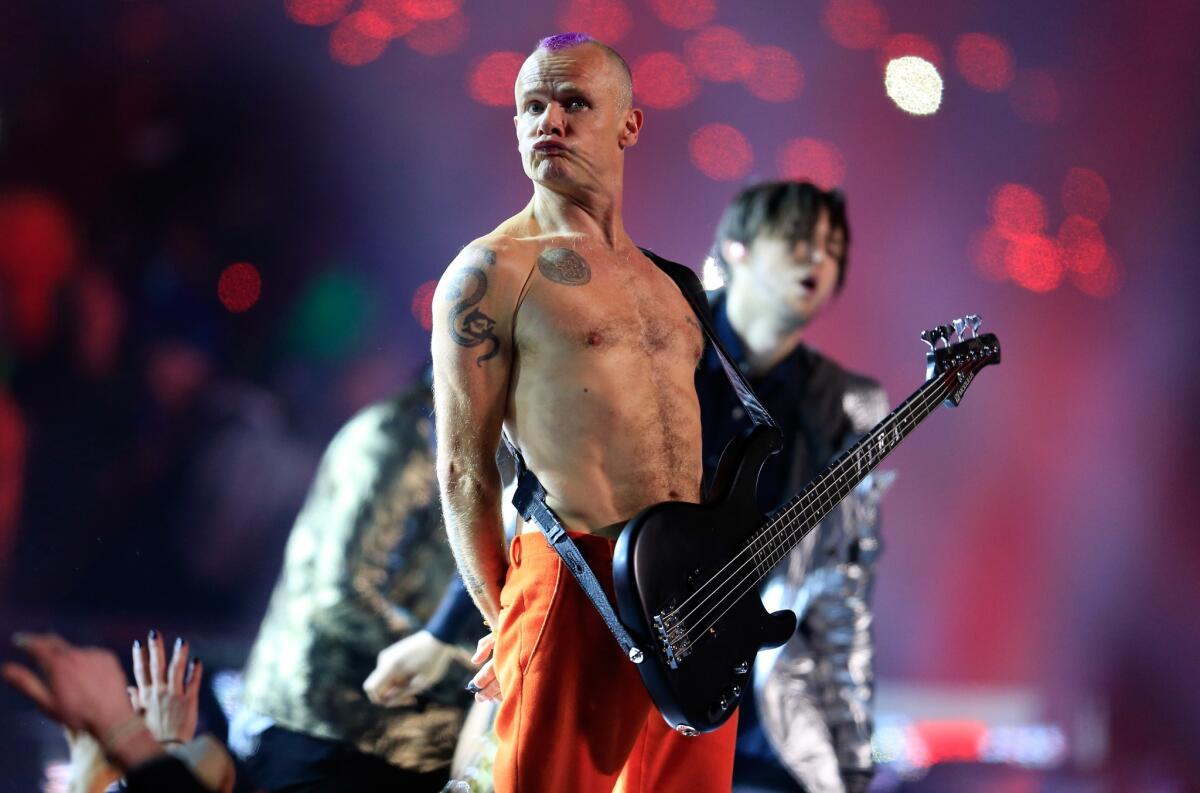 Flea of the Red Hot Chili Peppers strikes a pose during the halftime show at Sunday's Super Bowl in East Rutherford, N.J.