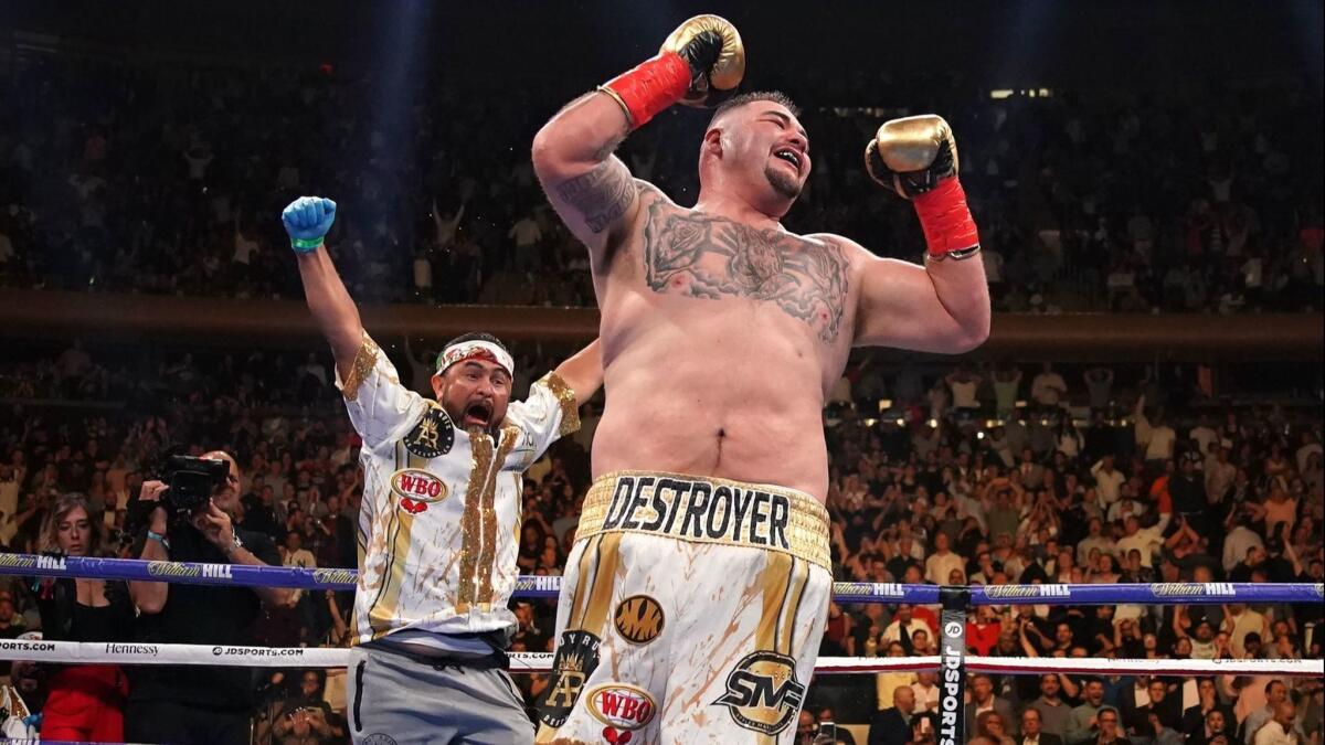 Andy Ruiz Jr. celebrates as trainer Manny Robles runs into the ring to join him after his stunning victory over previously unbeaten three-belt heavyweight champion Anthony Joshua on June 1.