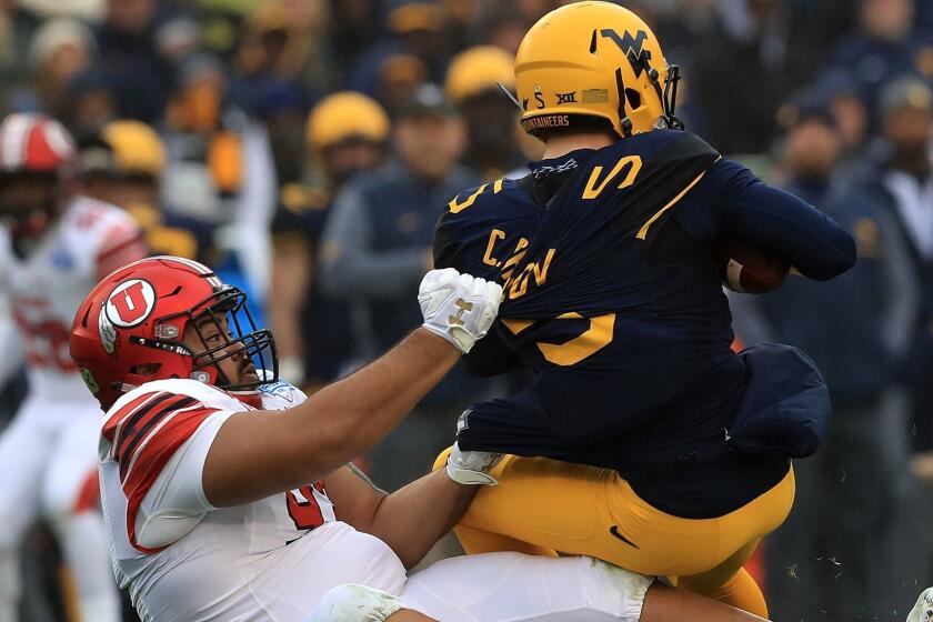 DALLAS, TX - DECEMBER 26: Chris Chugunov #5 of the West Virginia Mountaineers is sacked by Lowell Lotulelei #93 of the Utah Utes in the second quarter during Zaxby's Heart of Dallas Bowl on December 26, 2017 at Cotton Bowl in Dallas, Texas. (Photo by Ronald Martinez/Getty Images) ** OUTS - ELSENT, FPG, CM - OUTS * NM, PH, VA if sourced by CT, LA or MoD **