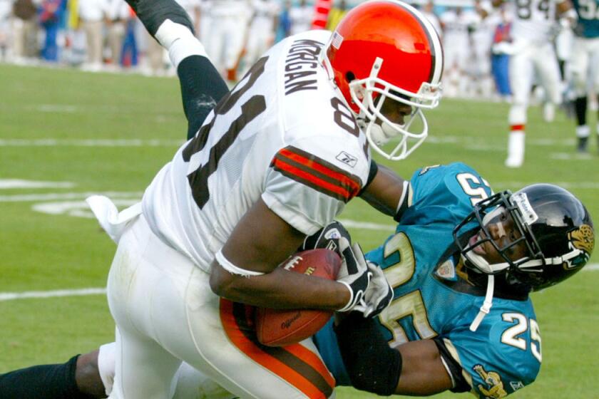 Cleveland Browns receiver Quincy Morgan (81) makes a touchdown catch against Jacksonville Jaguars defensive back Fernando Bryant on the game's final play for a 21-20 victory on Dec. 8, 2002.