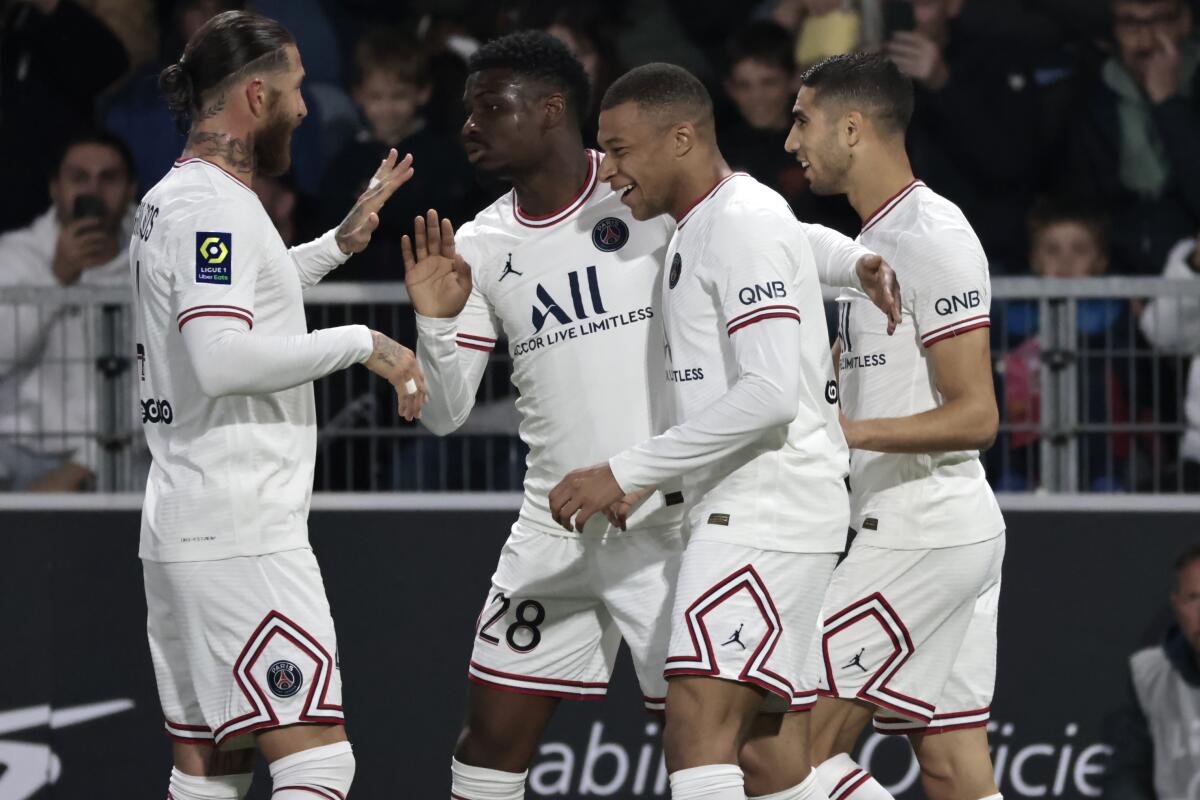 PSG's Kylian Mbappe, center right, celebrates his goal with teammates during the League One soccer match between Angers and Paris Saint Germain, at the Raymond-Kopa stadium in Angers, western France, Wednesday, April 20, 2022. (AP Photo/Jeremias Gonzalez)