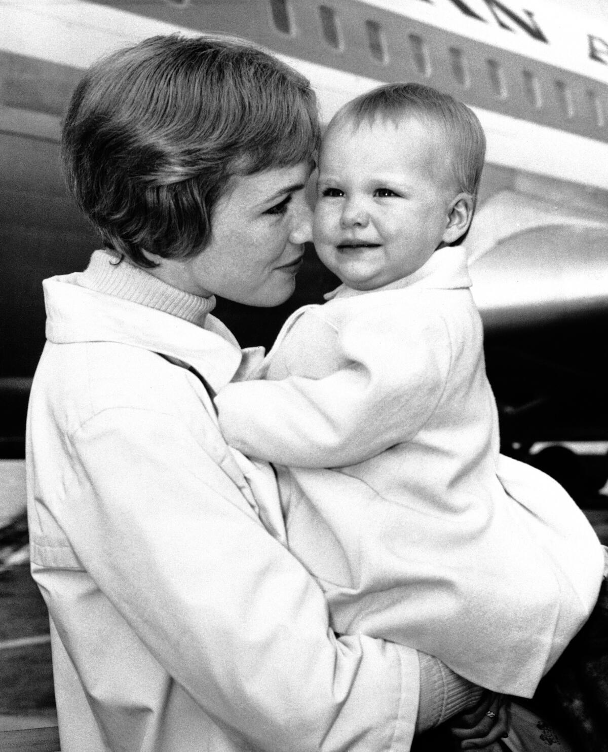 Black-and-white photo of a mother nuzzling her child 