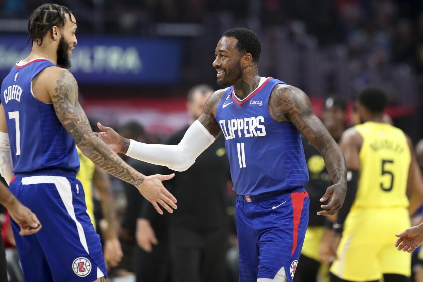 Los Angeles, CA - November 21:Clippers guard Amir Coffey, left, congratulates Clippers point guard John Wall after he scored a basket in the first half at Crypto.com Arena in Los Angeles Monday, Nov. 21, 2022. (Allen J. Schaben / Los Angeles Times)