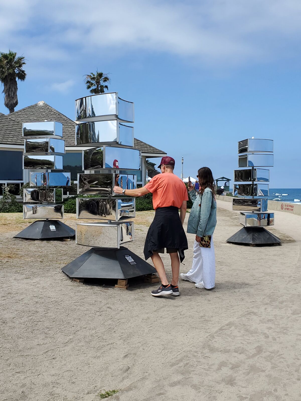 Visitors interact with the "Reflexion" installation in Scripps Park.