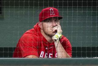 Los Angeles Angels' Mike Trout watches from the dugout during the ninth inning on Aug. 11, 2023, in Houston.